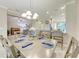 Open-concept living and dining area with modern furnishings and a kitchen featuring an island with seating at 13711 Messina Loop # 102, Lakewood Ranch, FL 34211