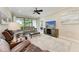 Spacious living room with a large sectional, recliner, tile flooring, and a sliding glass door to the outdoor patio at 13711 Messina Loop # 102, Lakewood Ranch, FL 34211