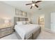 A spacious bedroom featuring light, neutral colors and adjoining bathroom at 13711 Messina Loop # 102, Lakewood Ranch, FL 34211