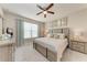 Comfortable main bedroom with a ceiling fan, decorative pillows and light wood furniture at 13711 Messina Loop # 102, Lakewood Ranch, FL 34211
