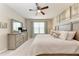 Comfortable main bedroom with a ceiling fan, decorative pillows and light wood furniture at 13711 Messina Loop # 102, Lakewood Ranch, FL 34211