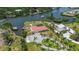 An elevated view of a waterfront home surrounded by lush greenery, a private dock, and beautiful landscaping at 1475 Bayshore Dr, Englewood, FL 34223