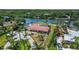 This aerial shot reveals a waterfront property with a private dock, lush vegetation, and serene surroundings at 1475 Bayshore Dr, Englewood, FL 34223