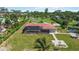 Aerial shot showcases the pool with screened enclosure, patio and spacious yard of this lovely property at 1475 Bayshore Dr, Englewood, FL 34223