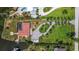 An aerial view of a beautiful home with lush landscaping, circular driveway, and waterfront access at 1475 Bayshore Dr, Englewood, FL 34223