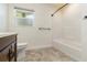 Bright bathroom featuring a shower-tub combo and a dark wood vanity at 1475 Bayshore Dr, Englewood, FL 34223