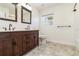 Bathroom with dark wood vanity, dual sinks, and a tiled floor at 1475 Bayshore Dr, Englewood, FL 34223