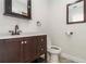 Bathroom with dark wood vanity, white sink and tiled floors at 1475 Bayshore Dr, Englewood, FL 34223