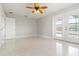 Bedroom featuring a ceiling fan, light gray walls, terrazzo flooring, and sliding door at 1475 Bayshore Dr, Englewood, FL 34223