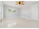 Bright bedroom with terrazzo floors, ceiling fan, window and door at 1475 Bayshore Dr, Englewood, FL 34223