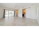 Airy bedroom featuring sliding doors to the lanai and a sliding barn door to the bath, complemented by light flooring at 1475 Bayshore Dr, Englewood, FL 34223