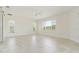 Spacious, sun-filled bedroom with light tile flooring, a ceiling fan, and multiple windows offering ample natural light at 1475 Bayshore Dr, Englewood, FL 34223
