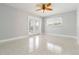 Bright bedroom with terrazzo floors, ceiling fan, and sliding glass doors to the outdoor area at 1475 Bayshore Dr, Englewood, FL 34223