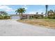 Street view of a single-story home with a two-car garage, showcasing its well-maintained exterior at 1475 Bayshore Dr, Englewood, FL 34223