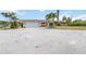 Street view of a single-story home with a two-car garage, showcasing its well-maintained exterior at 1475 Bayshore Dr, Englewood, FL 34223