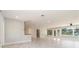 Spacious living area with tile flooring, neutral paint, and large windows leading to the screened lanai at 1475 Bayshore Dr, Englewood, FL 34223
