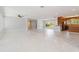 Open-concept living area with a seamless transition to the kitchen, complemented by bright, neutral paint and stylish flooring at 1475 Bayshore Dr, Englewood, FL 34223