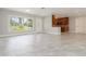 Open living space with tile flooring, and a partial view of the kitchen with wood cabinets at 1475 Bayshore Dr, Englewood, FL 34223