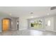 Bright living room with tile floors, neutral paint, and large window with a view of the front yard at 1475 Bayshore Dr, Englewood, FL 34223