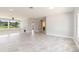 Bright and spacious living room with tile floors, neutral walls, and large windows with backyard view at 1475 Bayshore Dr, Englewood, FL 34223