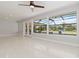 Bright living room featuring large windows with views of the screened-in lanai and pool at 1475 Bayshore Dr, Englewood, FL 34223