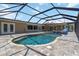 A gorgeous screened-in pool with a spill-over spa and beautiful brick paver decking offers a delightful backyard retreat at 1475 Bayshore Dr, Englewood, FL 34223