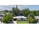 Aerial view of a single-story home with a boat in the driveway and mature trees at 1801 Marilyn Ave, Bradenton, FL 34207