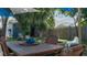 The backyard features an outdoor dining area with fire pit, mature trees, and shed at 1801 Marilyn Ave, Bradenton, FL 34207