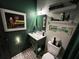 Stylish powder room featuring a modern vanity, art deco floor tile, and designer wall accents at 1801 Marilyn Ave, Bradenton, FL 34207