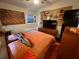 Cozy bedroom featuring a ceiling fan, orange bedding, stylish decor, and ample storage at 1801 Marilyn Ave, Bradenton, FL 34207