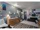 Cozy bedroom with trendy gray walls, a comfy couch, and unique decor and posters at 1801 Marilyn Ave, Bradenton, FL 34207