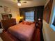 Retro bedroom featuring a stylish bed frame, dark wallpaper, and updated fixtures at 1801 Marilyn Ave, Bradenton, FL 34207