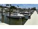 Daytime view of boats docked at a marina with slips on the water, with palm trees and clear skies in the background at 1801 Marilyn Ave, Bradenton, FL 34207