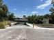 Concrete boat ramp leading to the water, surrounded by lush greenery and waterfront homes at 1801 Marilyn Ave, Bradenton, FL 34207