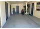 The carport with concrete flooring has storage, doors to the interior, and plenty of space for parking and other uses at 1801 Marilyn Ave, Bradenton, FL 34207