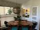 Bright dining room with vintage furniture, decorative lighting, and ample natural light at 1801 Marilyn Ave, Bradenton, FL 34207