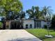 Single-story home with a well-kept lawn, mature landscaping, and a convenient carport at 1801 Marilyn Ave, Bradenton, FL 34207