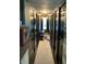 Long hallway with dark walls, multiple doors, and a stylish runner rug at 1801 Marilyn Ave, Bradenton, FL 34207