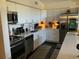Modern kitchen with stainless steel appliances, white cabinets, and sleek countertops at 1801 Marilyn Ave, Bradenton, FL 34207