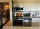 Well-equipped kitchen featuring modern appliances, white cabinets, and stylish backsplash at 1801 Marilyn Ave, Bradenton, FL 34207