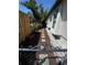 Landscaped side yard featuring a stone pathway, mulched garden beds, and lush greenery, enhancing curb appeal at 1801 Marilyn Ave, Bradenton, FL 34207