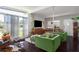 Inviting living room featuring large windows, green accent chairs, and dark hardwood floors at 1801 Marilyn Ave, Bradenton, FL 34207