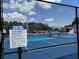 Outdoor pickleball court with rules posted, set against a backdrop of clear skies and trees at 1801 Marilyn Ave, Bradenton, FL 34207