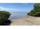 Picturesque waterfront featuring tranquil water, sandy beach, and lush vegetation at 1801 Marilyn Ave, Bradenton, FL 34207
