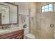 Bathroom featuring granite countertops, a glass-enclosed shower, and a neutral color palette at 1813 Boyce St, Sarasota, FL 34239