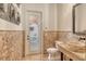 Cozy half-bathroom with unique stone sink and counter, travertine tile, and outdoor access at 1813 Boyce St, Sarasota, FL 34239