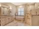 Elegant bathroom featuring a modern tub, glass shower, and vanity with a large mirror at 1813 Boyce St, Sarasota, FL 34239