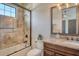 Bathroom featuring a tub with glass door, granite countertops, and decorative backsplash at 1813 Boyce St, Sarasota, FL 34239
