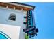Sign for cocktails hanging on the side of a building near a patio, inviting patrons to unwind at 1813 Boyce St, Sarasota, FL 34239
