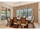 Bright dining room featuring brick accent wall, modern chandelier, and views to the screened patio at 1813 Boyce St, Sarasota, FL 34239